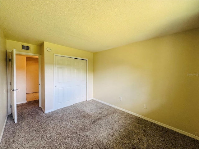 1695 Lee Rd Unit E214, Winter Park, FL 32789 - unfurnished bedroom with carpet, a closet, baseboards, and a textured ceiling
