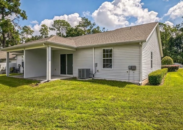 2503 SE 18th Cir, Ocala, FL 34471 - rear view of house featuring roof with shingles, a yard, a patio area, and central AC unit