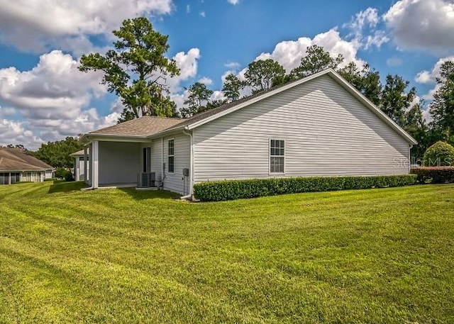 2503 SE 18th Cir, Ocala, FL 34471 - view of side of home featuring a yard and central air condition unit