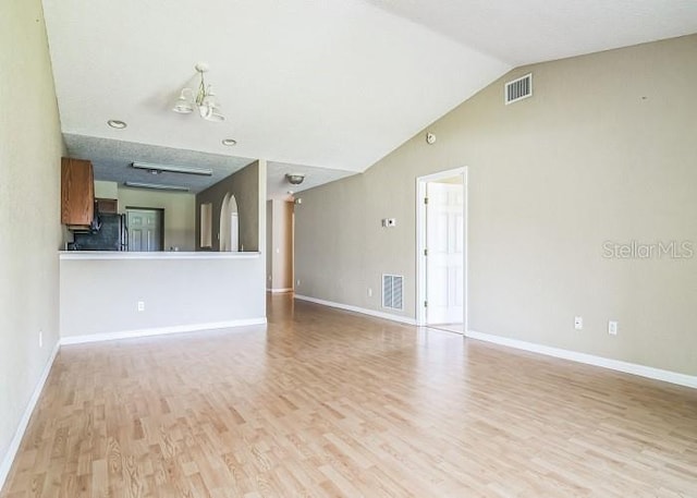 2503 SE 18th Cir, Ocala, FL 34471 - unfurnished living room with light wood-style floors, visible vents, baseboards, and vaulted ceiling