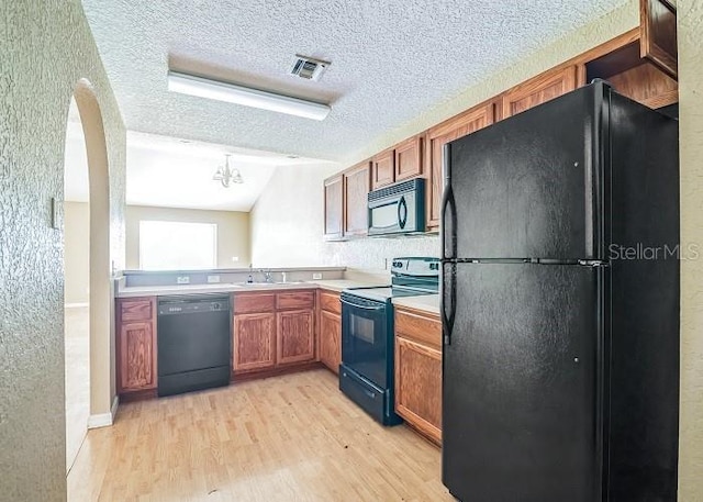 2503 SE 18th Cir, Ocala, FL 34471 - kitchen with light wood-style flooring, visible vents, light countertops, and black appliances