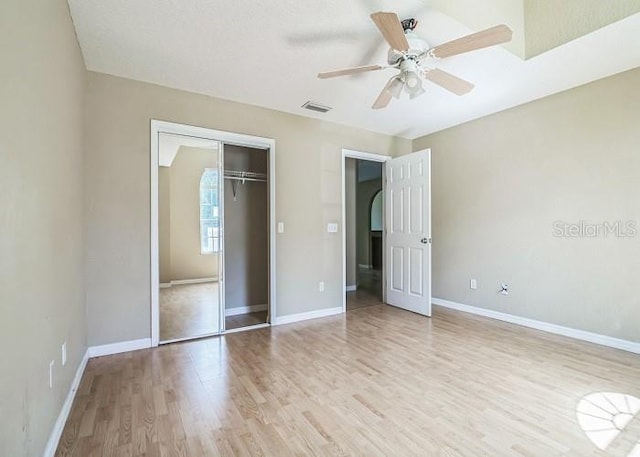 2503 SE 18th Cir, Ocala, FL 34471 - unfurnished bedroom with light wood-type flooring, a closet, arched walkways, visible vents, and baseboards