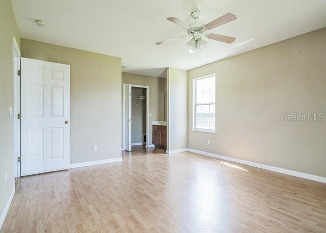 2503 SE 18th Cir, Ocala, FL 34471 - unfurnished bedroom with a closet, light wood-style flooring, a ceiling fan, and baseboards