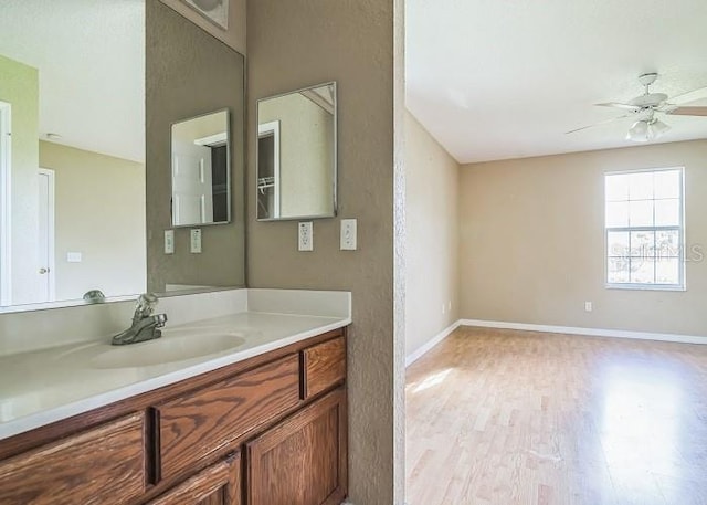 2503 SE 18th Cir, Ocala, FL 34471 - bathroom featuring ceiling fan, vanity, wood finished floors, and baseboards