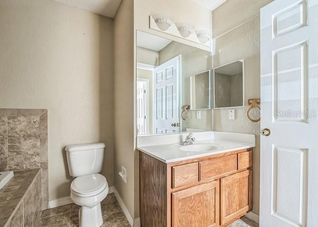 2503 SE 18th Cir, Ocala, FL 34471 - full bathroom featuring tiled bath, vanity, tile patterned flooring, toilet, and baseboards