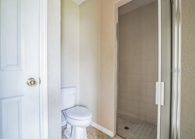 2503 SE 18th Cir, Ocala, FL 34471 - bathroom with a shower stall, baseboards, tile patterned flooring, and toilet
