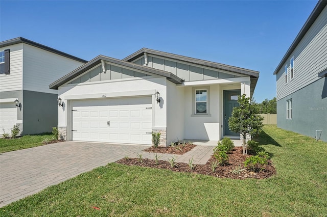 1861 Brekey Way, Zephyrhills, FL 33541 - view of front of home with board and batten siding, decorative driveway, a garage, a front yard, and stone siding