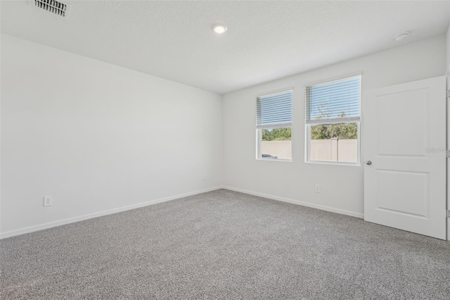 1861 Brekey Way, Zephyrhills, FL 33541 - spare room featuring carpet floors, baseboards, and recessed lighting