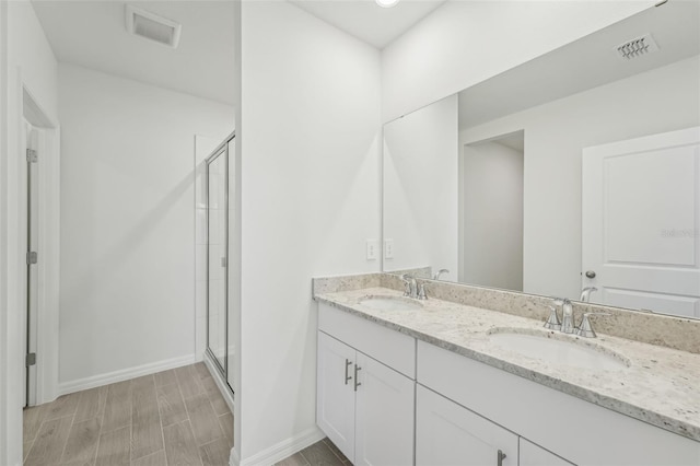 1861 Brekey Way, Zephyrhills, FL 33541 - full bathroom featuring a shower stall, double vanity, baseboards, and wood finished floors