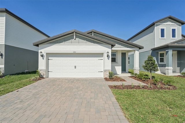 1861 Brekey Way, Zephyrhills, FL 33541 - view of front of property with decorative driveway, board and batten siding, an attached garage, a front lawn, and stone siding