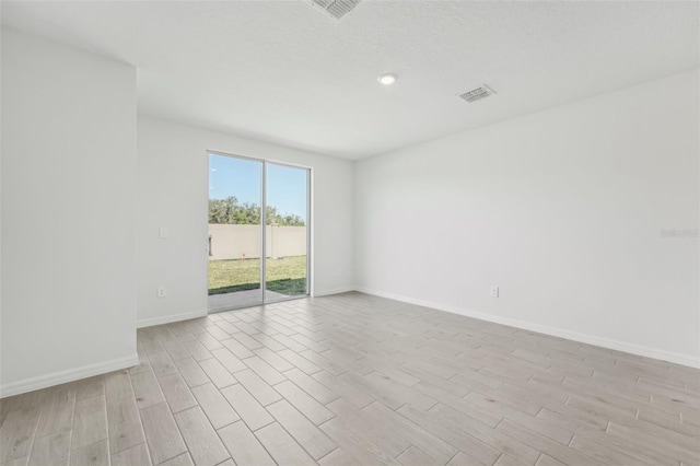 1861 Brekey Way, Zephyrhills, FL 33541 - spare room with light wood-style floors, baseboards, and recessed lighting
