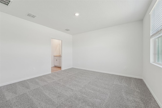 1861 Brekey Way, Zephyrhills, FL 33541 - unfurnished room featuring light carpet, baseboards, and recessed lighting