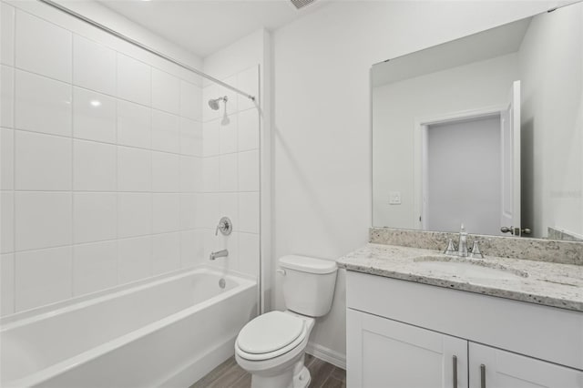 1861 Brekey Way, Zephyrhills, FL 33541 - full bath featuring toilet, vanity, wood finished floors, bathing tub / shower combination, and baseboards
