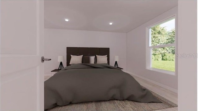 bedroom with baseboards and multiple windows