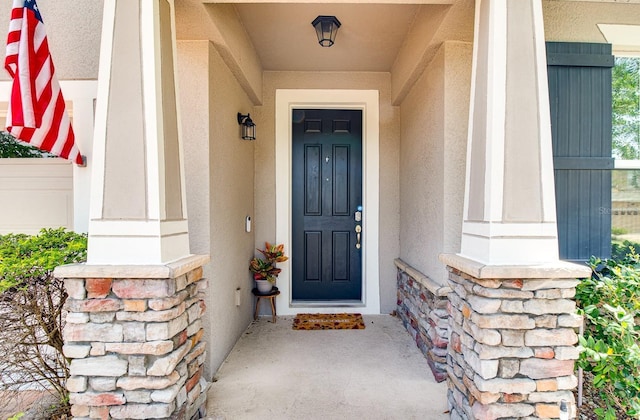2331 Kennington Cv, Deland, FL 32724 - view of exterior entry with stucco siding and stone siding
