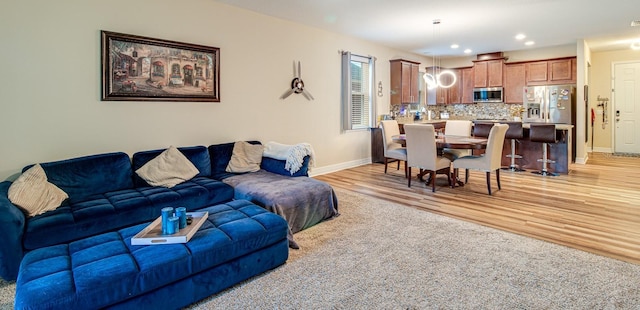 2331 Kennington Cv, Deland, FL 32724 - living room featuring light wood-style flooring, baseboards, and recessed lighting