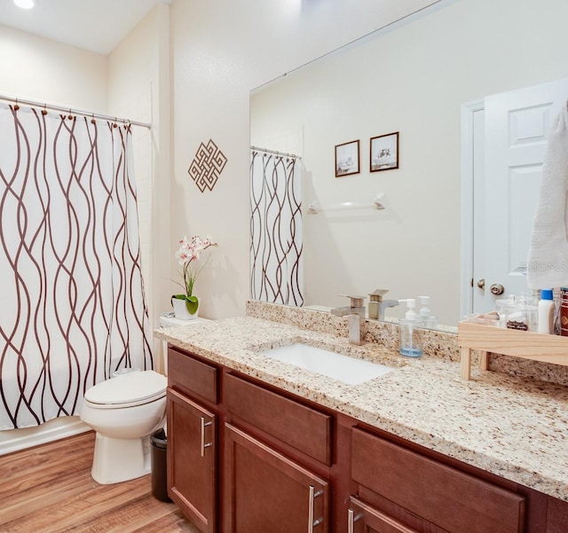 2331 Kennington Cv, Deland, FL 32724 - full bathroom featuring a shower with shower curtain, wood finished floors, toilet, and vanity