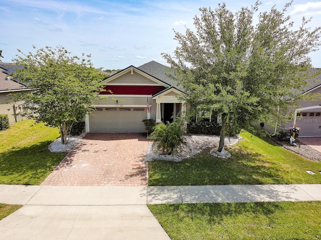 2331 Kennington Cv, Deland, FL 32724 - view of front of property with decorative driveway, a front yard, and a garage