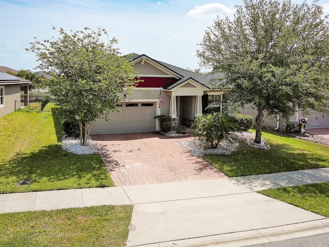 2331 Kennington Cv, Deland, FL 32724 - craftsman inspired home featuring a garage, stone siding, a front yard, and decorative driveway