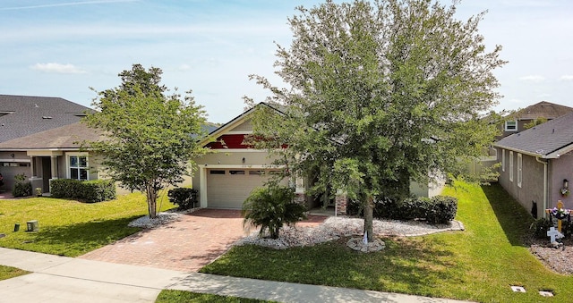 2331 Kennington Cv, Deland, FL 32724 - view of front of house with a garage, a front yard, and decorative driveway