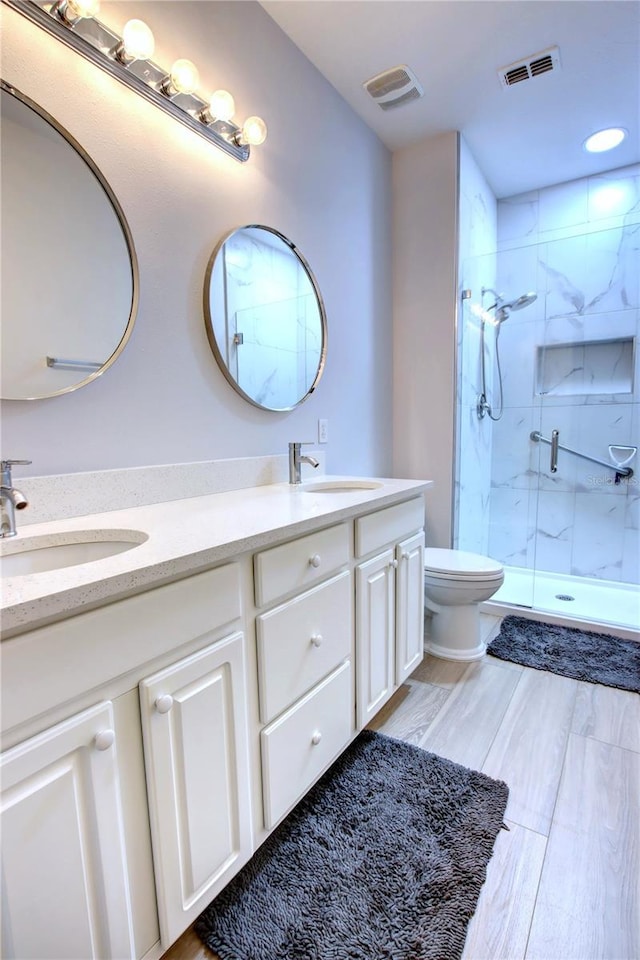 full bath featuring toilet, visible vents, and a sink