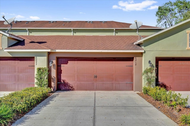 garage featuring concrete driveway