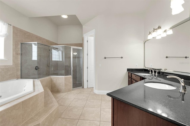 full bathroom featuring a sink, a stall shower, a garden tub, and tile patterned floors
