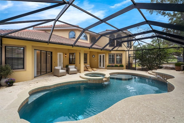 view of swimming pool featuring a pool with connected hot tub, a patio, and glass enclosure