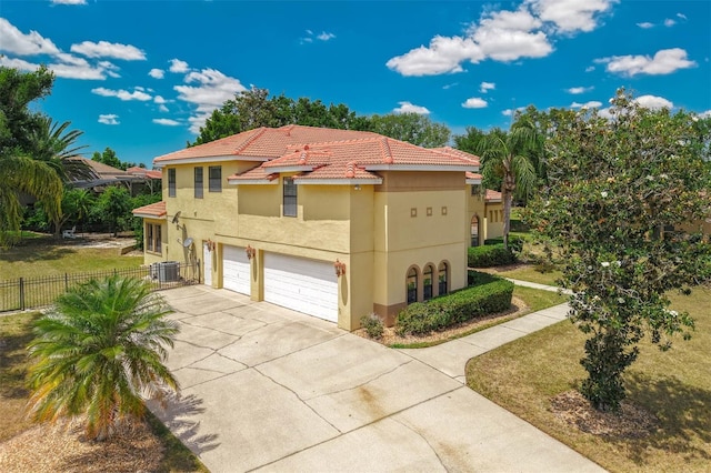 view of front of property featuring fence, an attached garage, stucco siding, and driveway