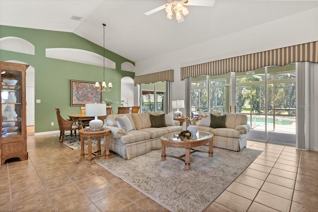 24104 Peekskill St, Leesburg, FL 34748 - tiled living room with a ceiling fan, high vaulted ceiling, a chandelier, and baseboards