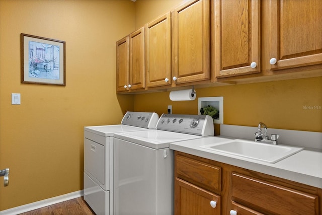 24104 Peekskill St, Leesburg, FL 34748 - laundry area with cabinet space, washer and dryer, baseboards, and wood finished floors