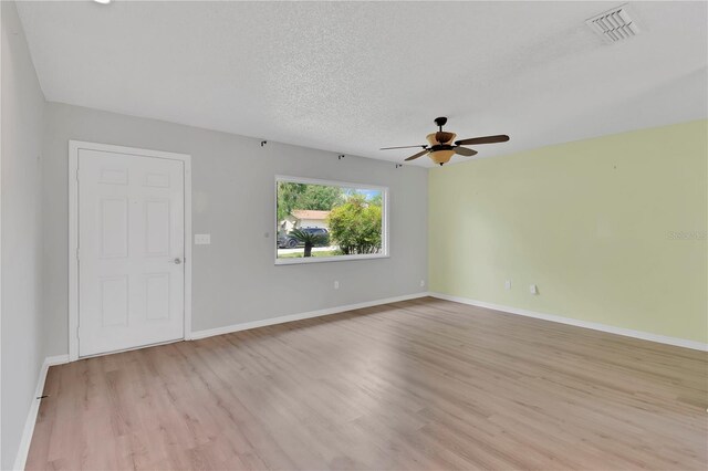 6366 SW 115th Street Rd, Ocala, FL 34476 - interior space with baseboards, light wood-style flooring, a textured ceiling, visible vents, and ceiling fan