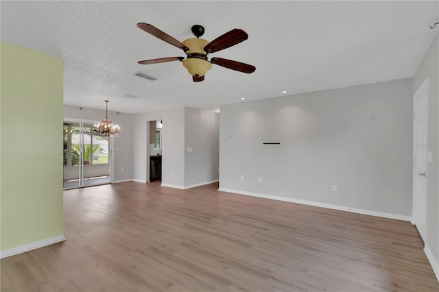 6366 SW 115th Street Rd, Ocala, FL 34476 - unfurnished living room featuring light wood finished floors, visible vents, ceiling fan with notable chandelier, and baseboards