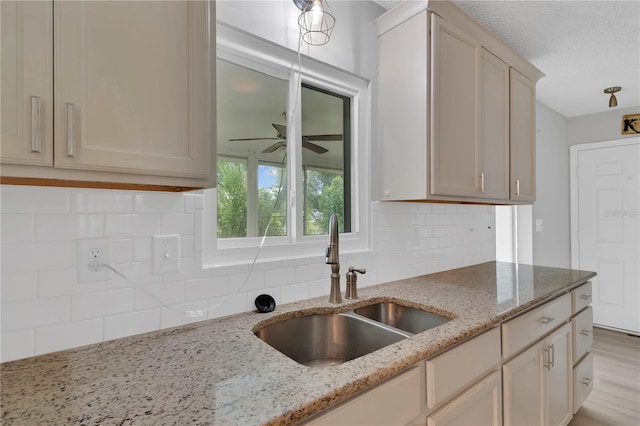 6366 SW 115th Street Rd, Ocala, FL 34476 - kitchen featuring a sink, backsplash, ceiling fan, and light stone countertops