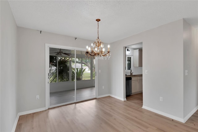 6366 SW 115th Street Rd, Ocala, FL 34476 - unfurnished dining area featuring an inviting chandelier, light wood finished floors, baseboards, and a sink