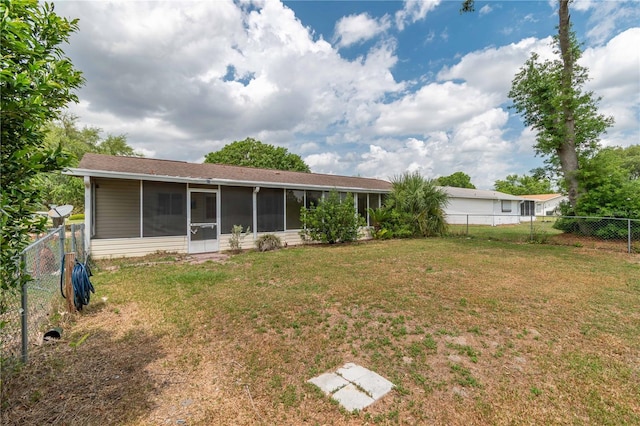 6366 SW 115th Street Rd, Ocala, FL 34476 - back of house with a fenced backyard, a sunroom, and a lawn