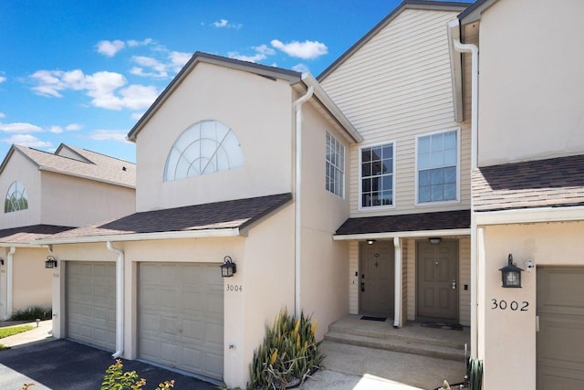 3004 Cottage Grove Ct Unit 1805, Orlando, FL 32822 - view of front of property with a shingled roof, asphalt driveway, and stucco siding