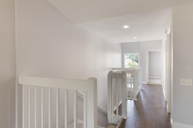 3004 Cottage Grove Ct Unit 1805, Orlando, FL 32822 - hall featuring an upstairs landing, a textured ceiling, hardwood / wood-style floors, and recessed lighting