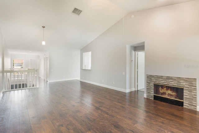 3004 Cottage Grove Ct Unit 1805, Orlando, FL 32822 - unfurnished living room with vaulted ceiling, dark wood-type flooring, and a fireplace