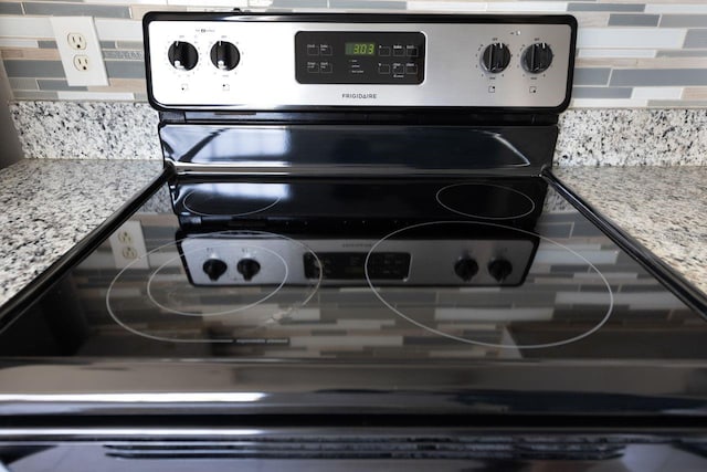3004 Cottage Grove Ct Unit 1805, Orlando, FL 32822 - kitchen view of stainless steel electric range oven and tasteful backsplash