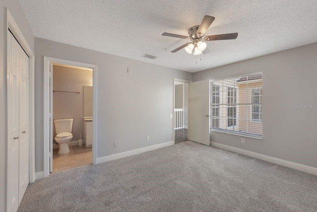 3004 Cottage Grove Ct Unit 1805, Orlando, FL 32822 - unfurnished bedroom with carpet floors, a textured ceiling, ensuite bath, a closet, and ceiling fan