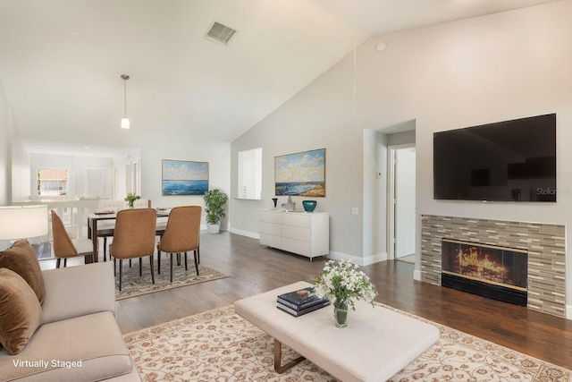 3004 Cottage Grove Ct Unit 1805, Orlando, FL 32822 - living area featuring wood finished floors, high vaulted ceiling, and a tiled fireplace