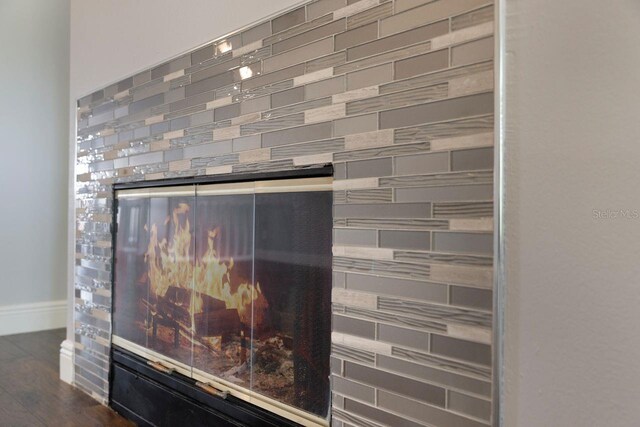3004 Cottage Grove Ct Unit 1805, Orlando, FL 32822 - detailed view of wood finished floors and a glass covered fireplace