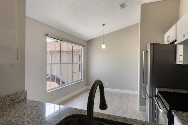 3004 Cottage Grove Ct Unit 1805, Orlando, FL 32822 - kitchen featuring white cabinetry, stone counters, hanging light fixtures, electric range, and light wood-type flooring