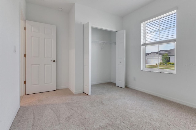 10008 Last Light Gln, Parrish, FL 34219 - unfurnished bedroom with carpet floors, baseboards, and a closet