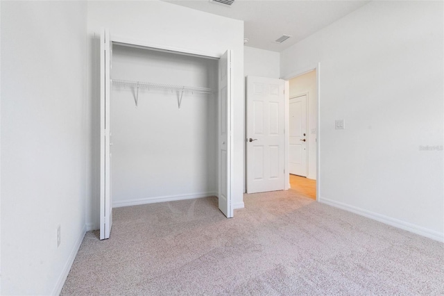 10008 Last Light Gln, Parrish, FL 34219 - unfurnished bedroom featuring a closet, carpet flooring, and baseboards