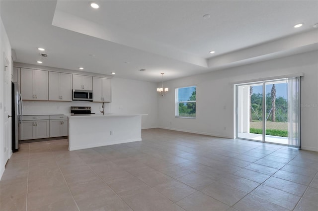 10008 Last Light Gln, Parrish, FL 34219 - kitchen featuring recessed lighting, a chandelier, a tray ceiling, and stainless steel appliances
