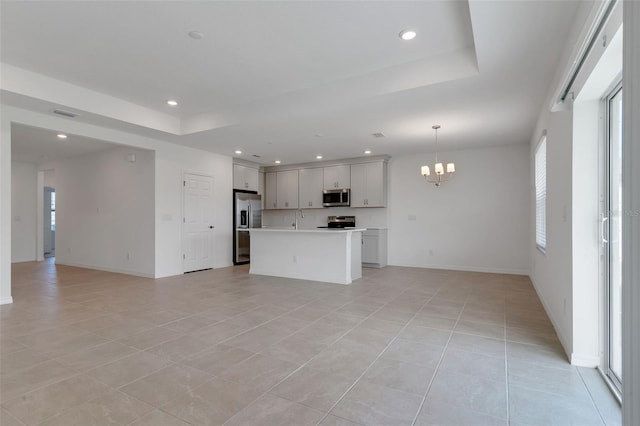 10008 Last Light Gln, Parrish, FL 34219 - kitchen featuring stainless steel appliances, open floor plan, a healthy amount of sunlight, and a tray ceiling