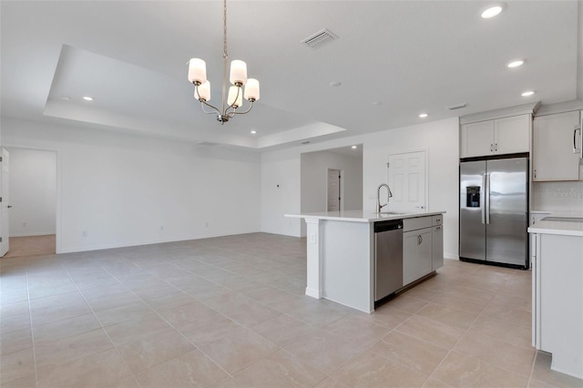 10008 Last Light Gln, Parrish, FL 34219 - kitchen featuring recessed lighting, light countertops, a raised ceiling, a sink, and stainless steel appliances