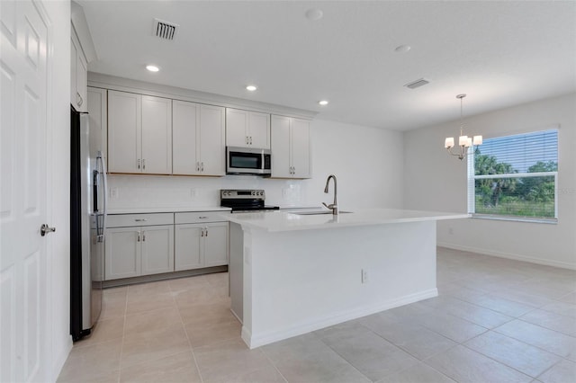 10008 Last Light Gln, Parrish, FL 34219 - kitchen with visible vents, light countertops, a sink, light tile patterned floors, and stainless steel appliances